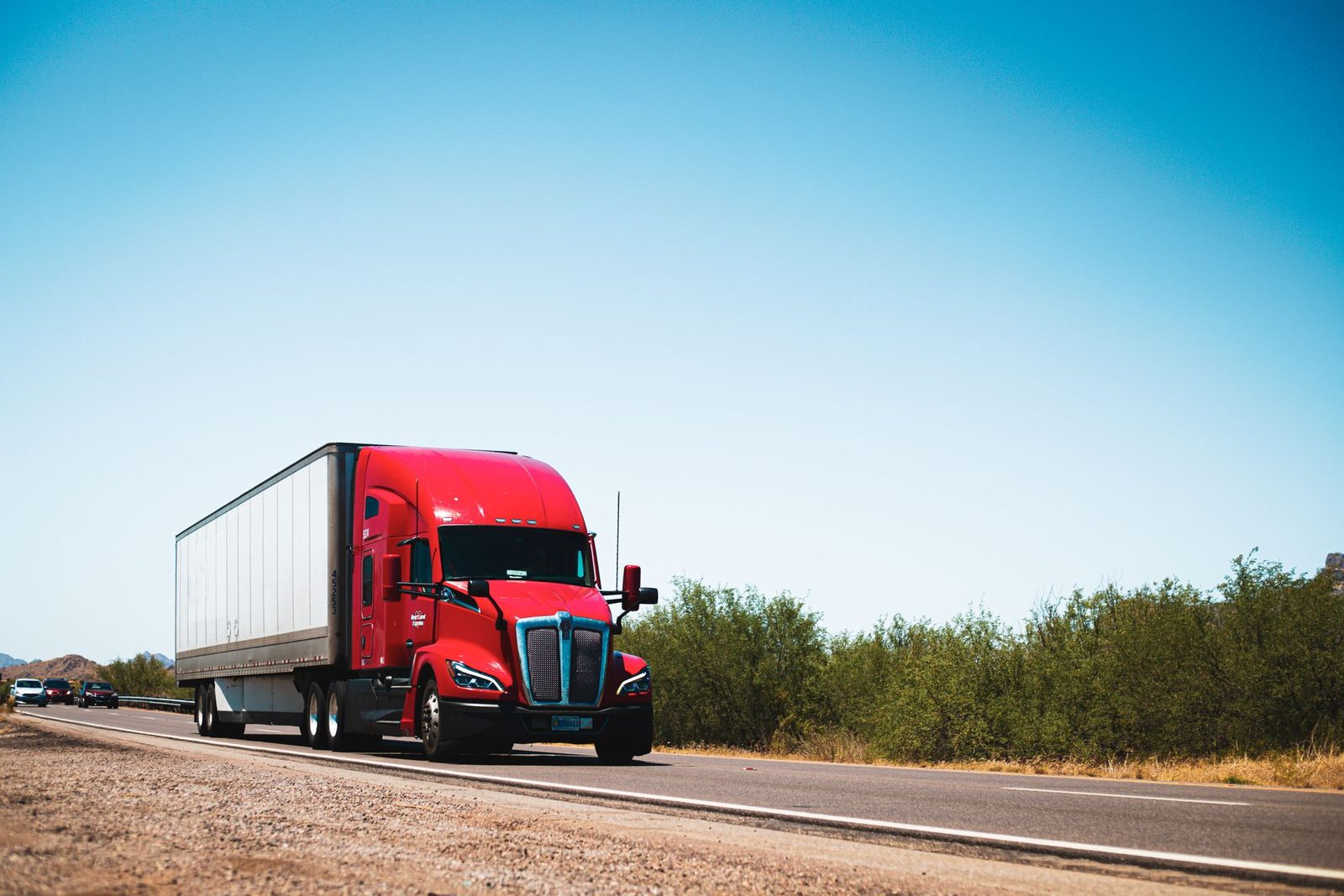 Tractor-trailer hauling a full truckload dry van on an open highway